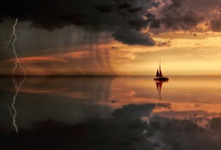 Sailing Storm - Silhouette Photography Of Boat On Water during Sunset