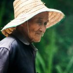Sunrise Thoughts - Asian senior woman with fishing net on natural background