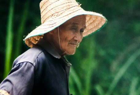 Sunrise Thoughts - Asian senior woman with fishing net on natural background