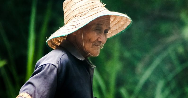 Sunrise Thoughts - Asian senior woman with fishing net on natural background