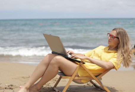 Computer Beach - Woman in Yellow Shirt Sitting on Brown Wooden Folding Chair on Beach