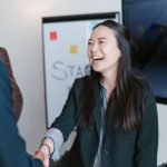 Network Handshake - Woman in Black Blazer Smiling