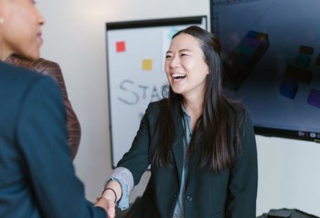 Network Handshake - Woman in Black Blazer Smiling
