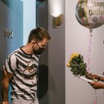 Balloon Job - A Deliverywoman Delivering a Balloon and a Bouquet of Flowers
