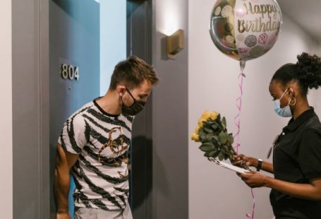 Balloon Job - A Deliverywoman Delivering a Balloon and a Bouquet of Flowers