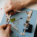 Resume Magnifying Glass - Hands of Person Assembling Transistors with Use of Magnifying Glass