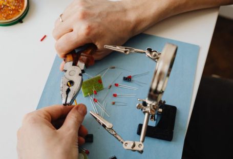 Resume Magnifying Glass - Hands of Person Assembling Transistors with Use of Magnifying Glass