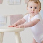 Baby Steps - Baby Holding White Wooden Stool
