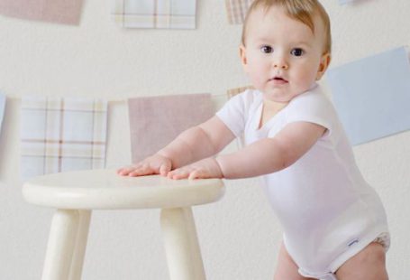 Baby Steps - Baby Holding White Wooden Stool