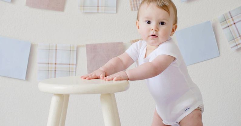 Baby Steps - Baby Holding White Wooden Stool