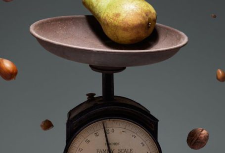 Scales Clock - Yellow and Red Round Fruit on Brown and White Weighing Scale