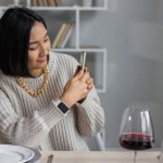Chain Digital - Content ethnic woman taking photo on smartphone