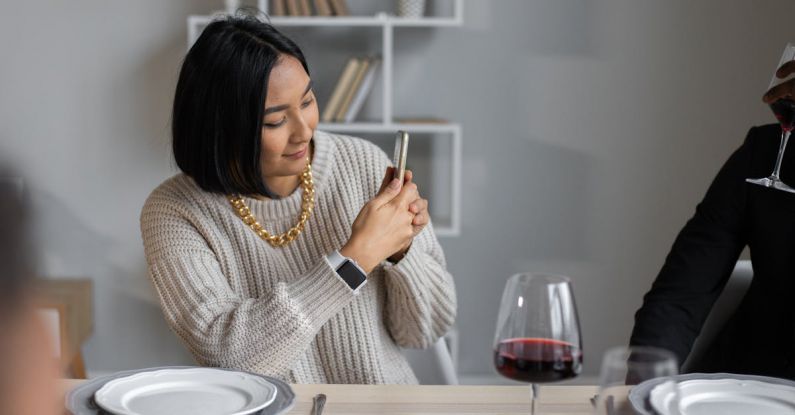 Chain Digital - Content ethnic woman taking photo on smartphone