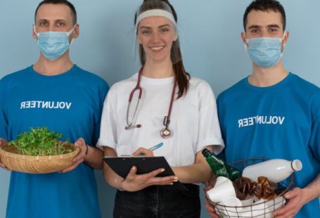 Hospital Future - Woman in White Crew Neck T-shirt Holding Black Tablet Computer Beside Man in Blue Crew