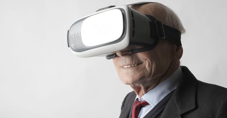 Watch Futuristic - Smiling elderly gentleman wearing classy suit experiencing virtual reality while using modern headset on white background