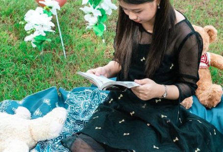 Book Balloons - Girl Reading a Book to Teddy Bears Sitting on a Blanket