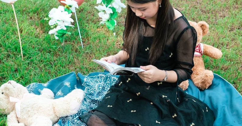 Book Balloons - Girl Reading a Book to Teddy Bears Sitting on a Blanket