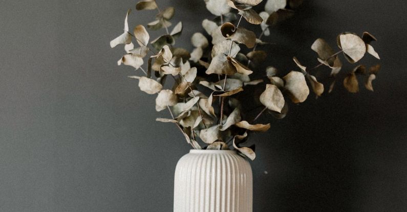 Books Gap - A white vase with a camera and a book on a shelf