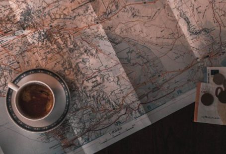 Money Book - White Ceramic Cup on Map
