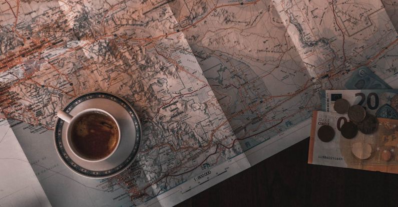 Money Book - White Ceramic Cup on Map