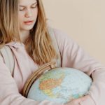 Backpack Globe - A Teenager Hugging a Globe