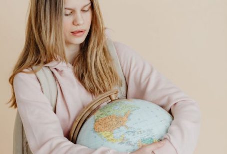 Backpack Globe - A Teenager Hugging a Globe