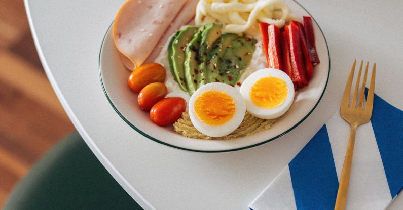 Brain Vegetables - A plate of food with eggs, bacon, and avocado