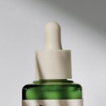 Dna Medicine - A bottle of green oil on a white surface