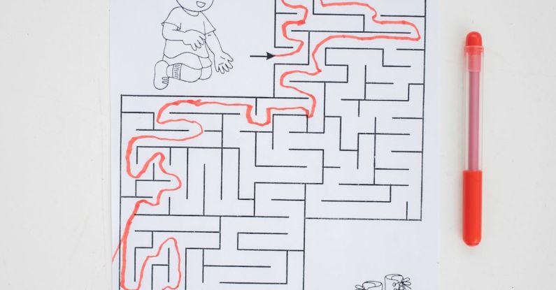 Paint Brain - Top view of solved labyrinth test with little boy and boots painted on paper placed on white desk with red pen