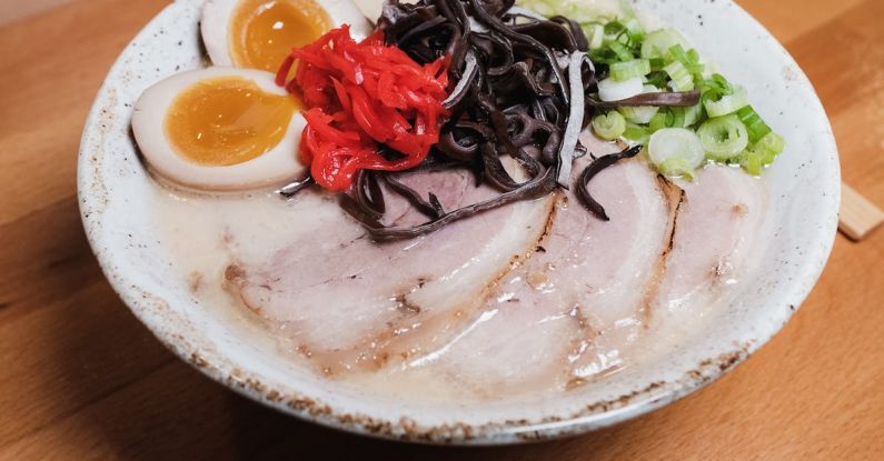 Pills Vegetables - A bowl of ramen with meat, eggs and vegetables