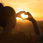 Hands Heart - Woman Sitting While Showing Heart Sign Hands